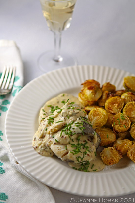Baked fish in mustard sauce with brussels sprouts