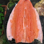 Whole butterflied salmon on the barbecue