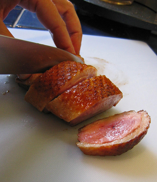 Slicing grilled duck breast