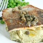 Pan-fried fish fillets with capers on pesto mash