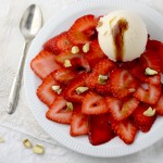 Strawberry carpaccio with smoked balsamic reduction and toasted pistachios