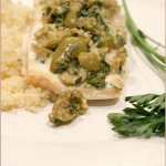 Baked salmon fillets with smashed olives, flat leaf parsley and garlic