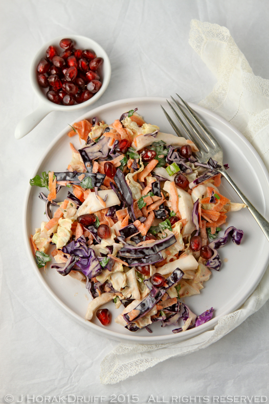 Spice up your coleslaw with the heat of harissa and the sweetness of pomegranate - a delicious twist on a classic!