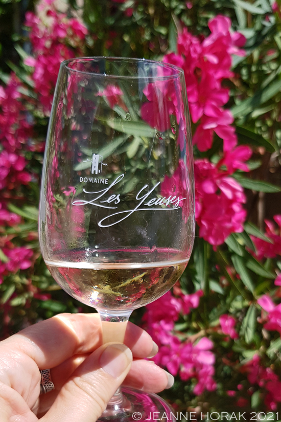 Glass of rosé wine with pink flowers