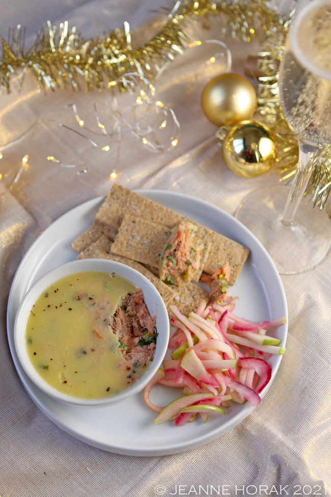 Plate of potted smoked salmon with slaw and a glass of champagne