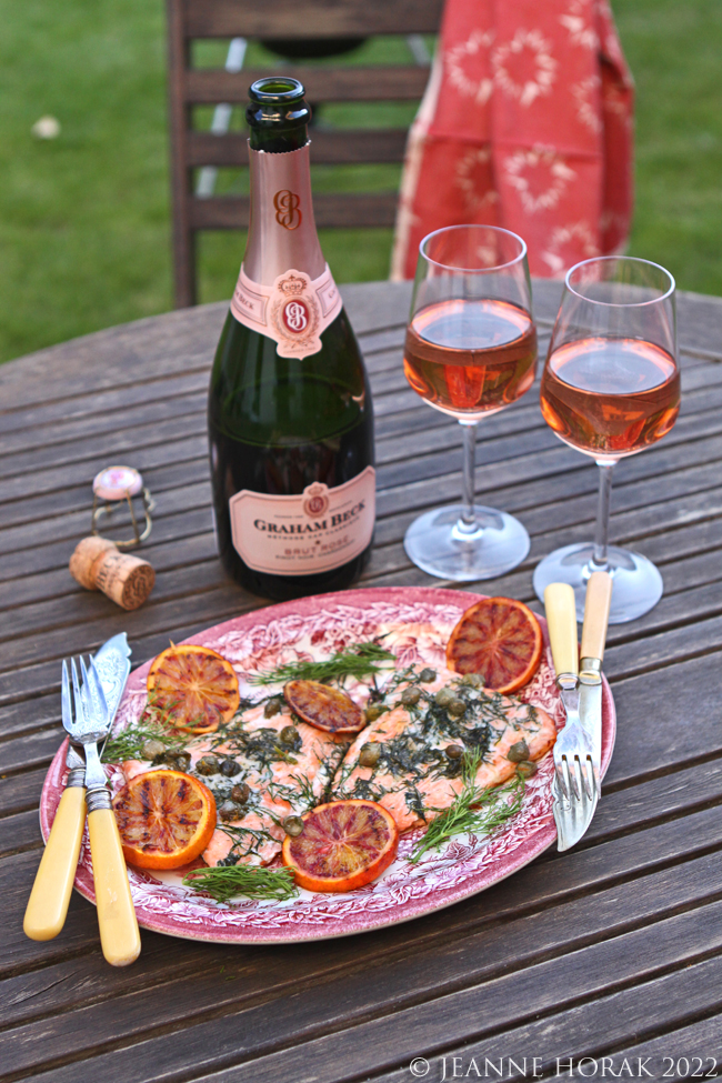 Barbecued salmon with blood oranges on a table